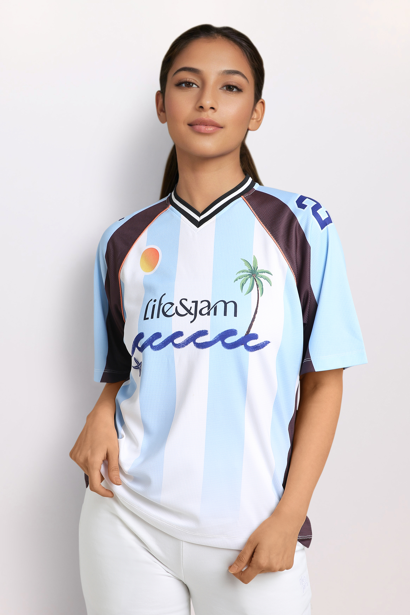 Athleisure model in studio setting - warm skin, dark eyes, cornrows, wearing black sports bra and black leggings